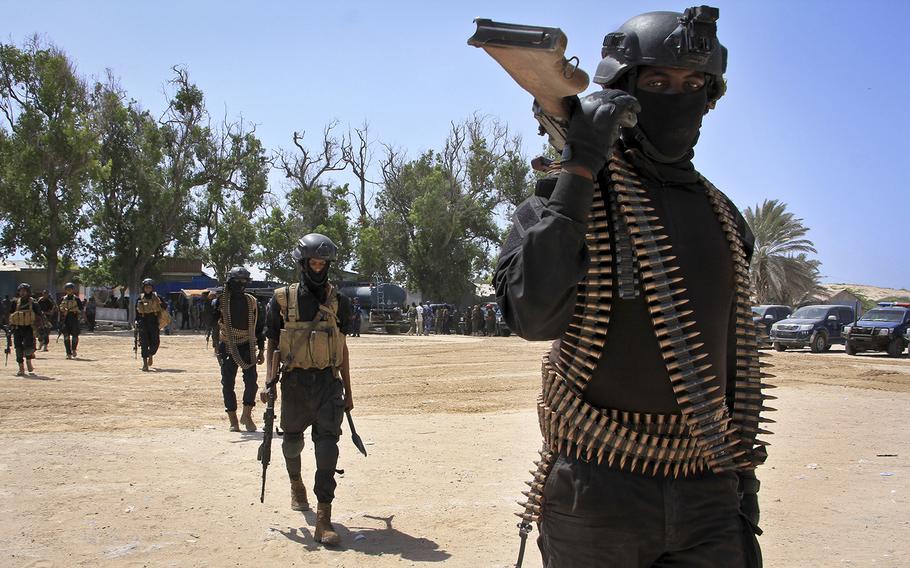Somali soldiers prepare to secure the capital on the eve of presidential elections, at a police academy in Mogadishu, Somalia Tuesday, Feb. 7, 2017.