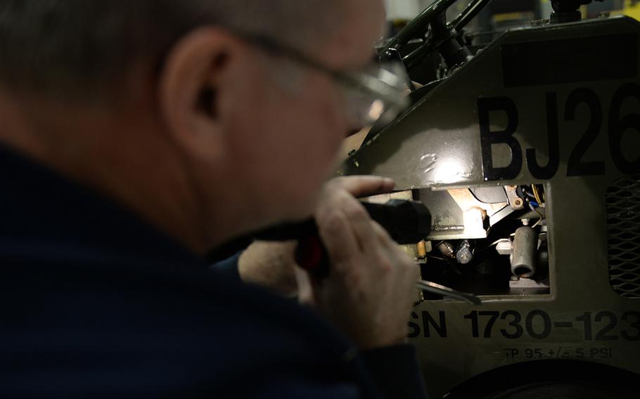Department of the Air Force employee Robert Wurster, a 354th Maintenance Squadron aerospace ground equipment technician, inspects a MJ-1 bomb lift Dec. 5, 2016, at Eielson Air Force Base, Alaska.