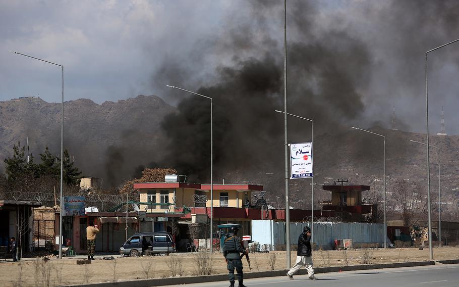 Smoke rises from a district police headquarters after a suicide bombing in Kabul, Afghanistan, Wednesday, March 1, 2017.