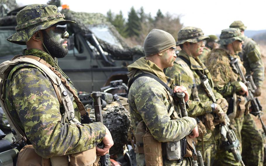Canadian and U.S. soldiers displaying weapons and equipment during Exercise Allied Spirit, March 17, 2017.