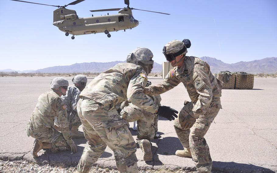 Staff Sgt. Russell Horton, right, talks to Pvt. Ephrium Nicholson, left, both assigned to Headquarters and Headquarters Company, 1st Armored Division Sustainment Brigade, train at Biggs Army Airfield, Texas, March 10, 2017. Soldiers from the 1st Armored Division will deploy later this year to Iraq and Afghanistan.