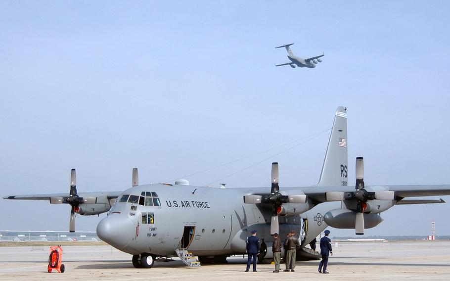 A U.S. Air Force C-17 Globemaster III, named "Spirit of Berlin", passes over Rhein-Main Air Base, Germany, and a Ramstein-based C-130 Hercules, at the Rhein-Main Air Base closure ceremony on Oct. 10, 2005.
(enw# 61p cs)