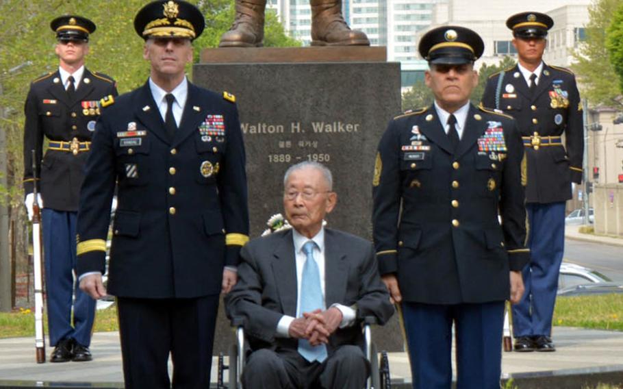 Lt. Gen. Thomas Vandal, from left, 8th Army commander, retired South Korean Gen. Paik Sun-yup and Command Sgt. Maj. Richard Merritt pose in front of the bronze statue of Korean War hero Lt. Gen. Walton Walker at Yongsan Garrison in Seoul, South Korea, Tuesday, April 25, 2017.