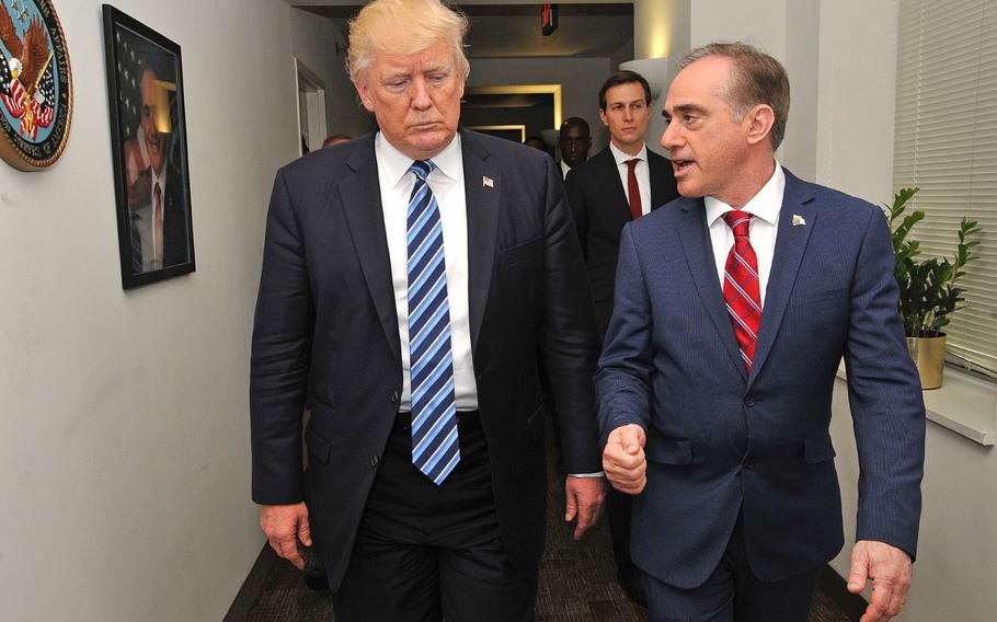 President Donald Trump and Secretary of Veterans Affairs David Shulkin walk through a hallway at the VA's Central Office on Thursday, April 27, 2017. Shulkin said Wednesday that he has a team investigating a Washington, D.C. VA hospital that was named in an Inspector General report.