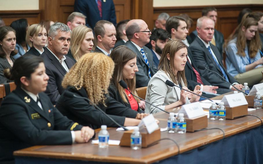Former Navy midshipman Annie Kendzior, at far right, testifies on Tuesday, May, 2, 2017, during a House Armed Services subcommittee hearing in which members heard testimony from sexual assault victims as part of an overview of an annual report on sexual harassment and violence at the military service academies. Making quotation marks with her fingers, Kendzior alleged that Adm. Robert Clark, then-Commandant U.S. Naval Academy, told her to "grow up" when she requested to be moved away from her company, where she said she was raped twice by fellow classmates. Other witnesses testifying along with Kendzior are from left: Navy Midshipman 2nd Class Sheila Craine, Former Army cadet Ariana Bullard, and former cadet Stephanie Gross.
