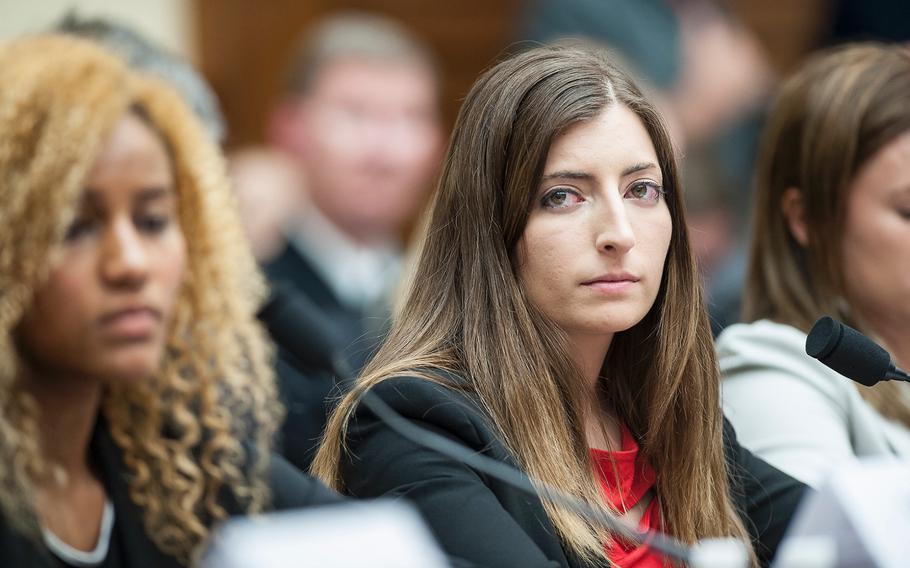 Former Army cadet Stephanie Gross looks on as another witness testifies on Tuesday, May, 2, 2017, during a House Armed Services subcommittee hearing in which members heard testimony from sexual assault victims as part of an overview of an annual report on sexual harassment and violence at the military service academies. At left is former Army cadet Ariana Bullard and at right former Navy midshipman Annie Kendzior. Not seen is Navy Midshipman 2nd Class Sheila Craine.