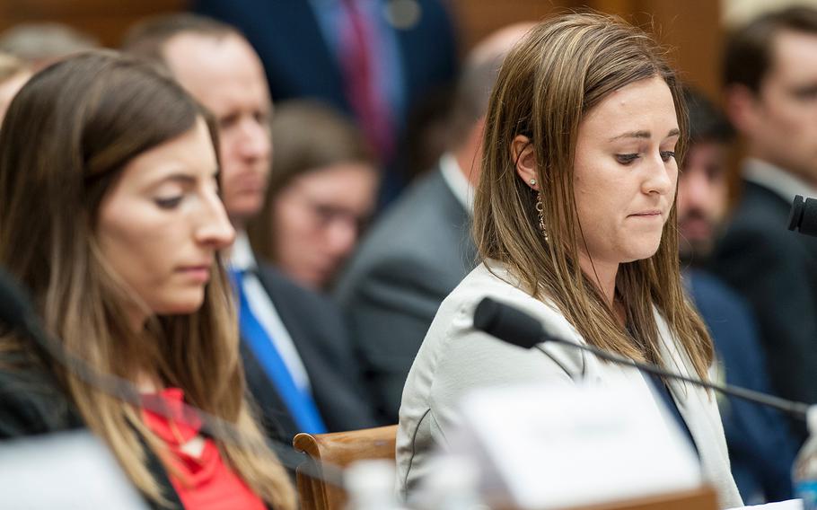 Former Navy midshipman Annie Kendzior, right, looks down while testifying on Tuesday, May, 2, 2017, during a House Armed Services subcommittee hearing in which members heard testimony from sexual assault victims as part of an overview of an annual report on sexual harassment and violence at the military service academies. At left is former Army cadet Stephanie Gross who also testified.