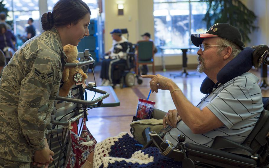 In a December, 2016 file photo, U.S. Air Force Airman 1st Class Maygan Straight speaks with retired Air Force Chief Master Sgt. Ron Evans during a visit to the Veterans Victory House in Walterboro, S.C.