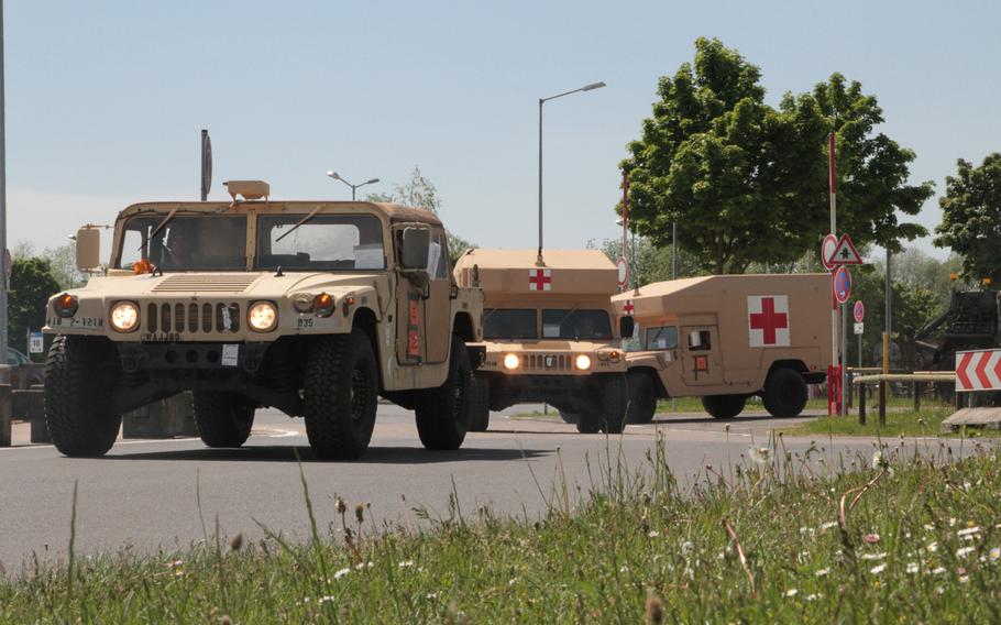 A High Mobility Multipurpose Wheeled Vehicle (HMMWV) and two military ambulances from the 2nd Battalion, 12th Infantry Regiment depart in a convoy from Nuremberg Airport, Germany on May 16, 2017. The light infantry unit recently completed an Emergency Deployment Readiness Exercise to Germany and is moving to Grafenwoehr Training Area for follow-on exercises over the next month.