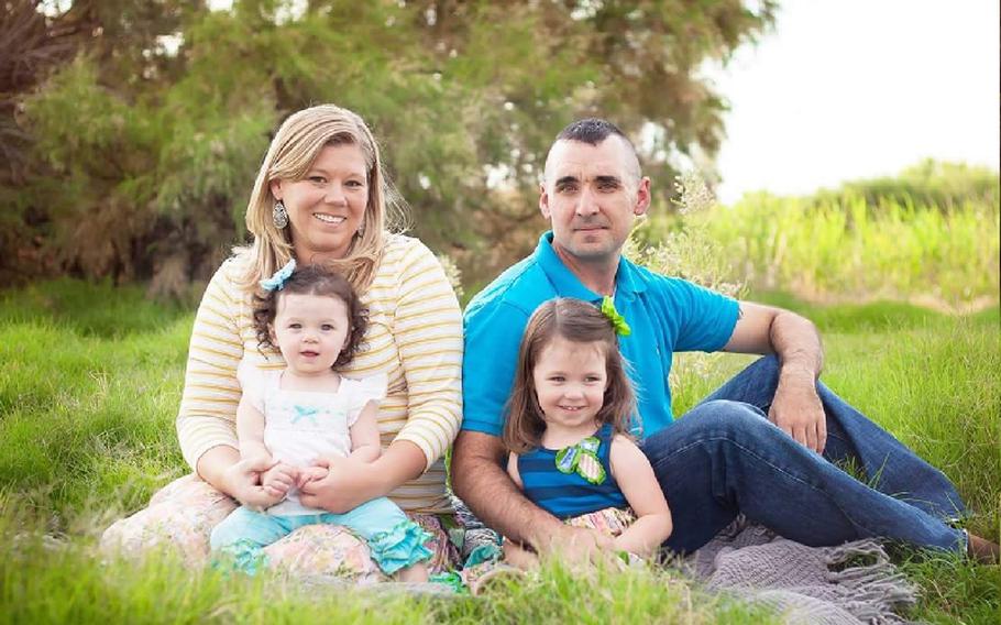 Army Capt. Daniel Doyle (posthumously promoted to major after his death) seen in a photo with his wife Cynthia and two daughters Emmalyn and Leah.