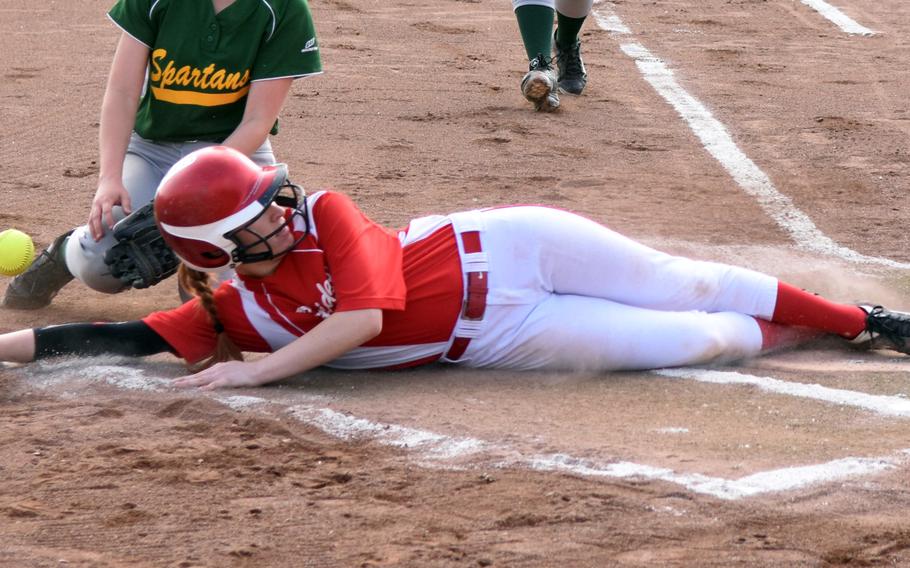 Pheonix Whisennand of Kaiserslautern slides just under the tag as the ball bounces away during a game against SHAPE on the first day of the softball championships at Kaiserslautern, Germany, Thursday, May 25. 