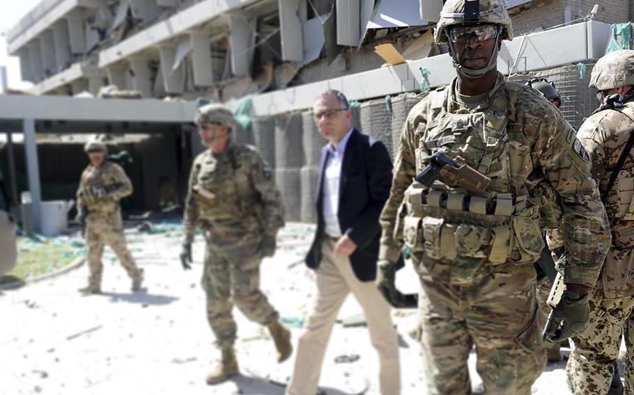 Military personnel are seen at the site of the May 31, 2017, suicide bombing that killed scores of people and wounded hundreds more. On Friday, June 2, Afghan police fired warning shots and fought a running battle with angry anti-government protesters.