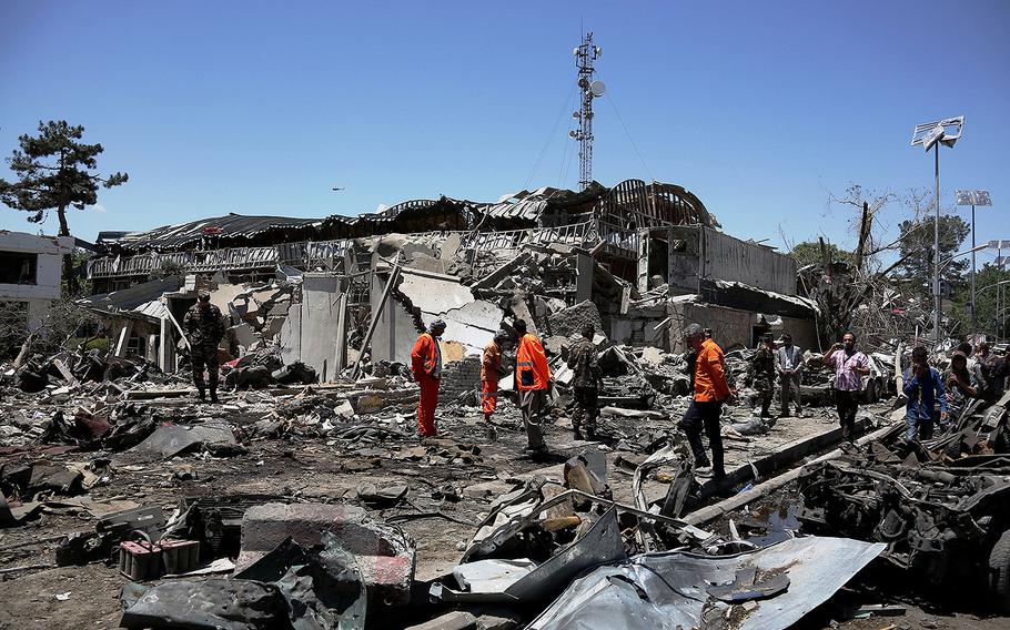 Rescue workers comb through the site of a car bomb explosion on May 31, 2017 in Kabul, Afghanistan.