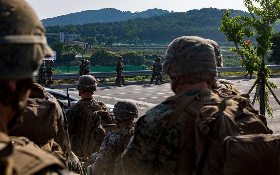 U.S. Marines and sailors with India Company, 3rd battalion, 8th Marines, forward deployed to the 3rd Marine Division, as part of the forward Unit Deployment Program, observe Republic of Korea Marines hiking on Camp Mujuk, South Korea on May 29, 2017.