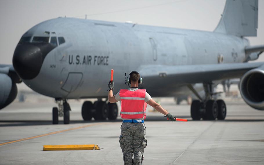 A U.S. Air Force airman with the 379th Expeditionary Aircraft Maintenance Squadron marshals a KC-135 Stratotanker at Al Udeid Air Base, Qatar on May 29, 2017.