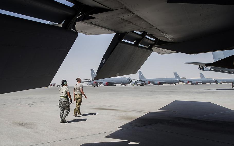 A KC-135 Stratotanker pilot, assigned to the 340th Expeditionary Air Refueling Squadron, walks with a maintainer, assigned to the 340th Aircraft Maintenance Unit, before a mission at Al-Udeid Air Base, Qatar, May 31, 2017.