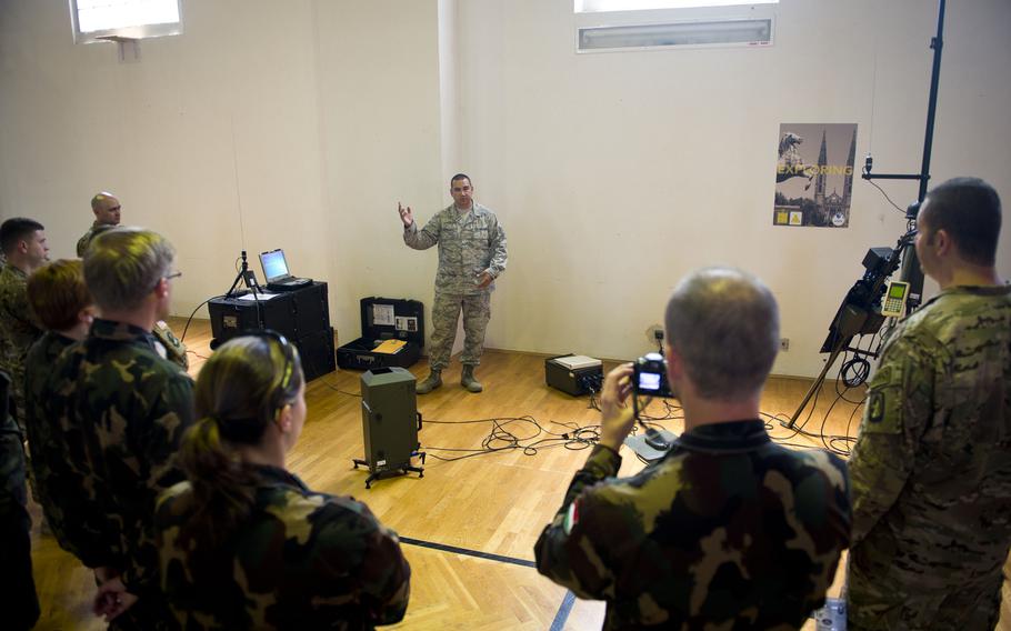 U.S. Air Force Tech. Sgt. Christopher Hardy, from the 7th Weather Squadron, describes the radio transmitting capabilities of a Tactical Meteorological Observing System during Exercise Cadre Focus 17-1 at McCully Barracks, Germany, on Wednesday, June 14, 2017. 