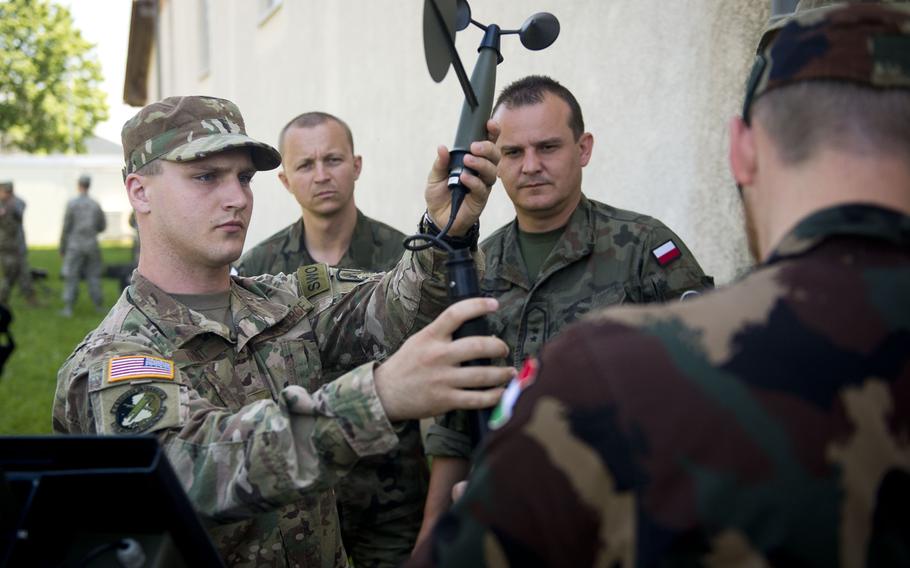 Airman 1st Class Athon Arant demonstrates how to assemble a Tactical Meteorological Observing System for Polish and Hungarian weather troops during Exercise Cadre Focus 17-1 at McCully Barracks, Germany, on Wednesday, June 14, 2017. 
                