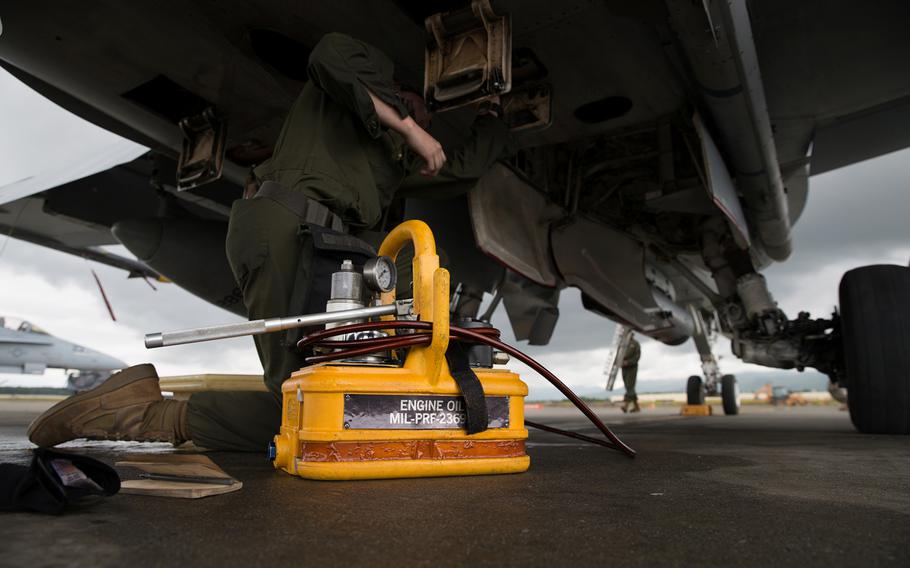 A fixed wing aircraft mechanic assigned to Marine Fighter Attack Squadron 251 conducts maintenance on an F/A-18C Hornet during Red Flag-Alaska 17-2 on Joint Base Elmendorf-Richardson, Alaska, June 14, 2017.