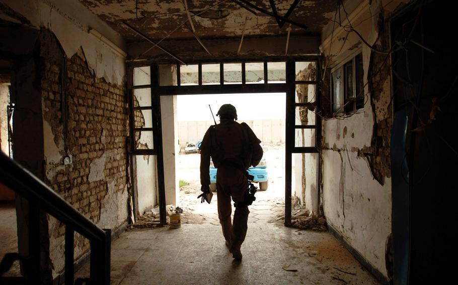 A U.S. servicemember leaves a recently bombed Baghdad police station after providing training to Iraqi police in Baghdad on May 9, 2007. The military coalition fighting against Islamic State militants in Iraq said Thursday, July 6, 2017, that 100 expeditionary police stations will be delivered to Iraqi forces in regions recently liberated from ISIS.