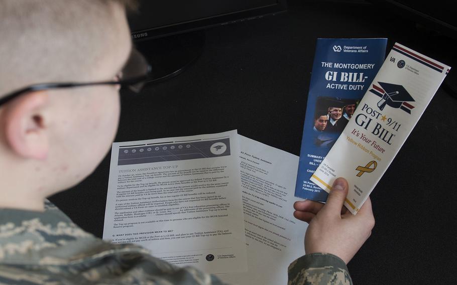 Airman Dalton Shank, 5th Bomb Wing public affairs specialist, reads pamphlets on the Montgomery GI Bill and the Post-9/11 GI Bill at Minot Air Force Base, N.D., March 10, 2017.