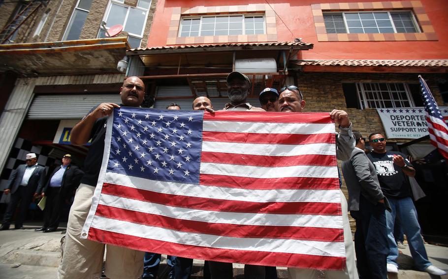 Deported veterans hold a U.S. flag in Tijuana, Mexico, on June 3, 2017 as seven members of Congress visited the Deported Veterans Support House.