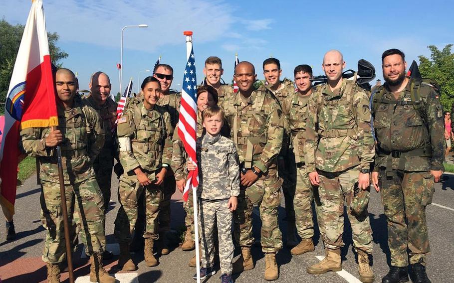 Stan Buurman, center, a ten-year-old Dutch boy, poses with U.S. and German soldiers from U.S. Army Europe along the Four Days of Nijmegen march route near Elst, the Netherlands, Tuesday, July 18, 2017. Buurman is an avid fan of history and the military, and has had a U.S. uniform since he was seven. 