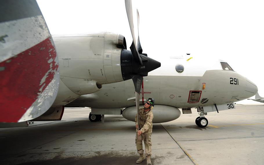 In a 2010 file photo, Navy Petty Officer 1st Class Joshua Gerke, Combined Task Group 57.1 aviation machinist, performs a pre-flight prop inspection on an EP-3 reconaissance aircraft at a non-disclosed Southwest Asia location.