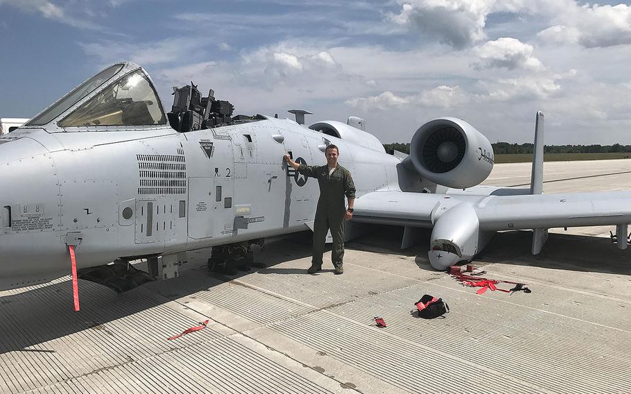 Capt. Brett DeVries, an A-10 Thunderbolt II pilot of the 107th Fighter Squadron from Selfridge Air National Guard Base, poses next to the aircraft he safely landed after a malfunction forced him to make an emergency landing July 20, 2017 at the Alpena Combat Readiness Training Center.