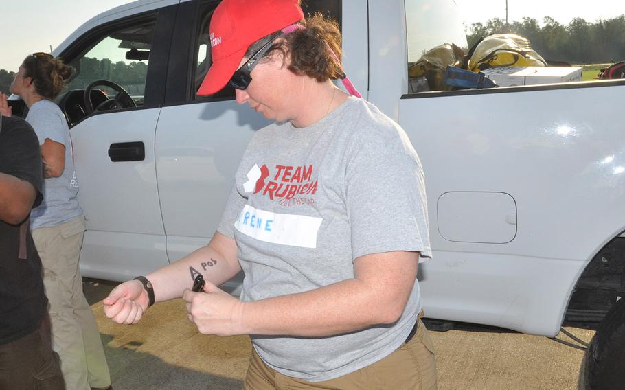Irene Mason, a former Army officer from Waveland, Miss., writes her blood type on her arm ahead of a search and rescue boat mission on the floodwaters of Hurricane Harvey in Beaumont, Texas on Sept. 2, 2017. Mason, who was also an enlisted Marine, is a member of the non-profit veterans organization Team Rubicon, that utilizes veterans skills to respond to disasters. 