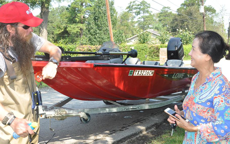 Team Rubicon volunteer Stephen Reid speaks with Van Ngo in Beaumont Texas on Sept. 2, 2017 after his rescue boat team helped her retrieve medication and clothing items from her flooded home. The non-profit veterans organization utilizes veterans skills to respond to disasters. 