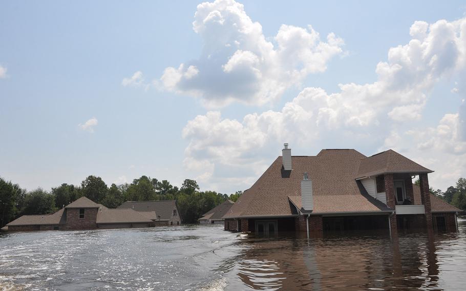 Flooding in a Beaumont, Texas, neighborhood near the Pine Island Bayou left homes underwater and vehicles submerged. The water was still high on Sept. 2, 2017, but had started to recede.