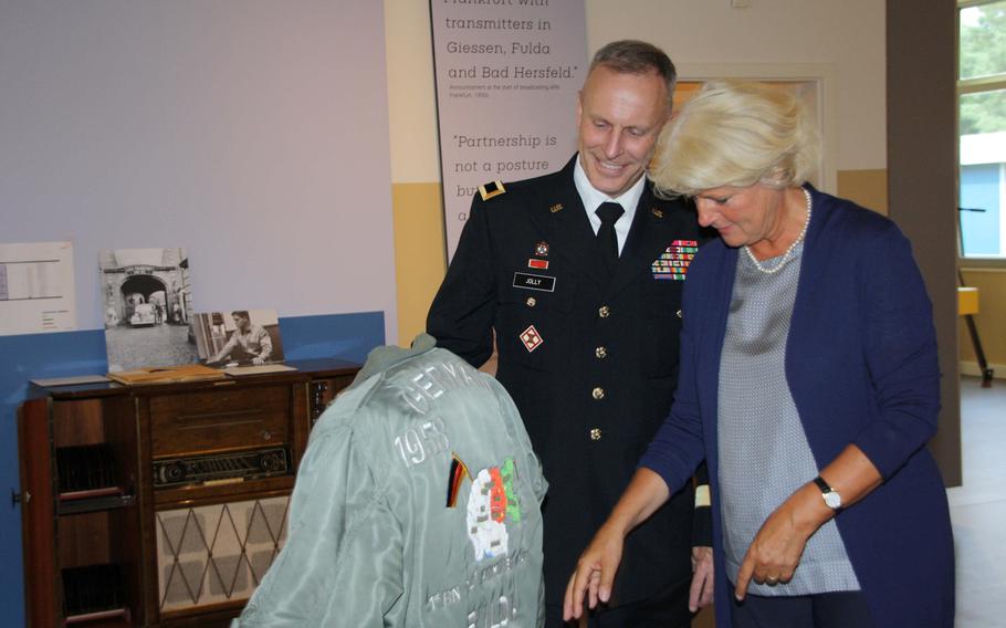 Brig. Gen. Philip Jolly of U.S. Army Europe and German Commissioner for Culture and the Media Monika Gruetters, examine a Cold War-era pilots jacket at the Point Alpha memorial near Geisa, Germany. 