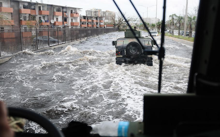 Soldiers of the Puerto Rico National Guard patrol one of the main highway of the metropolitan area affected by the flood after the Hurricane Maria on Sept. 22, 2017.