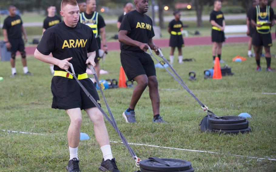 Pfc. Alex Colliver, front, pulls a 90-pound sled 50 meters that simulates the strength needed in pulling a battle buddy out of harm's way during a pilot program for the Army Combat Readiness Test at Fort Lee, Va., Sept. 14, 2017.