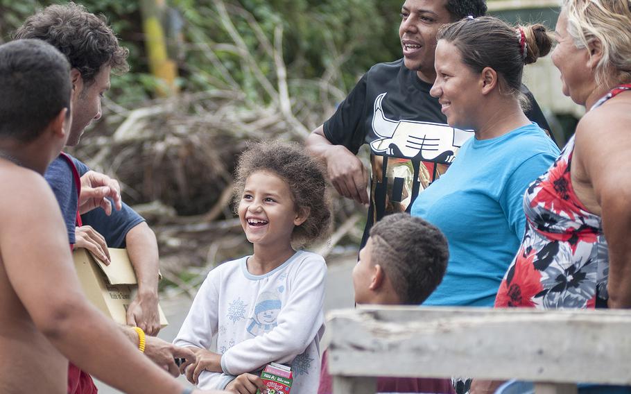 Members of one family in the Comerio region of Puerto Rico were all smiles after receiving a water purifying system, a solar-powered lamp and other gifts on Thursday, Nov. 9, 2017, as a team of Red Cross volunteers visited the area.