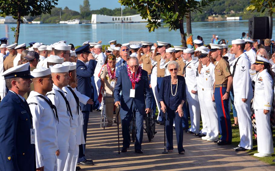 Donald Stratton, a USS Arizona survivor, and his wife, Velma, depart the ceremony through an honor cordon at Pearl Harbor Visitor's Center, Thursday, Dec. 7, 2017. 
