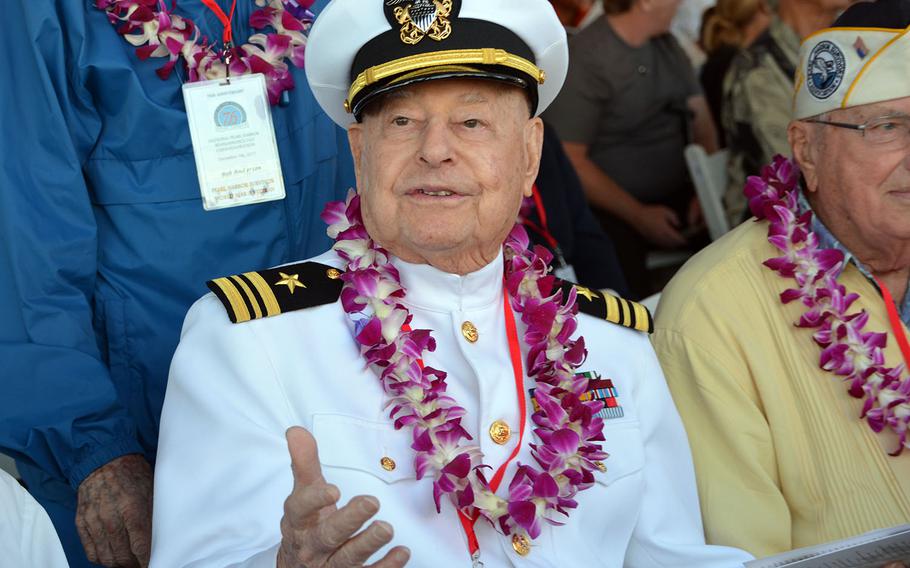An unidentified sailor who was aboard the USS Arizona during the Japanese surprise attack on Dec. 7, 1941, chats with others before the 76th anniversary ceremony began at the Pearl Harbor Visitor's Center, Thursday, Dec. 7, 2017.