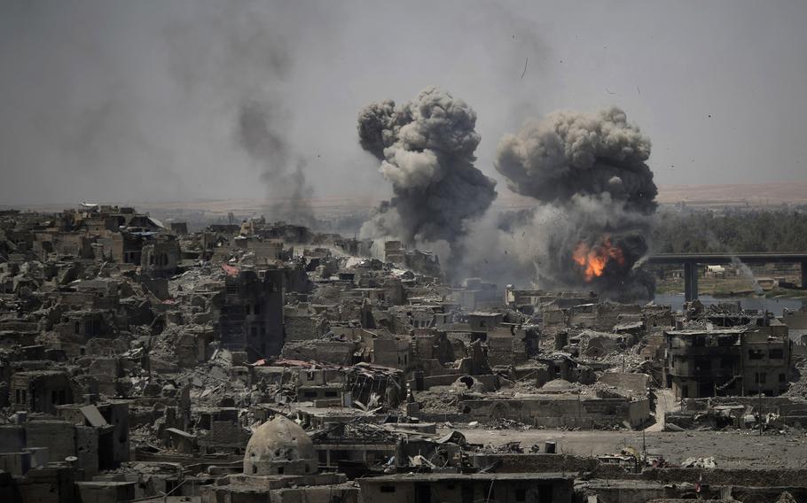 In this July 11, 2017 file photo, airstrikes target Islamic State positions on the edge of the Old City in Mosul, Iraq. 