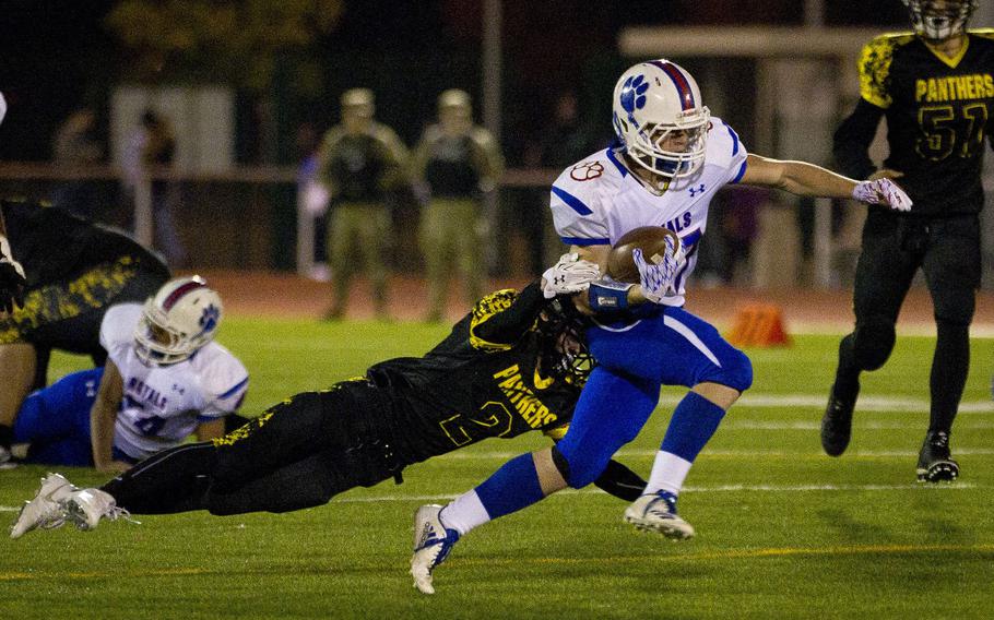 Ramstein's Bailey Holland, right, breaks a tackle by Stuttgart's Will Tonder at Vogelweh, Germany, on Saturday, Nov. 4, 2017.
                