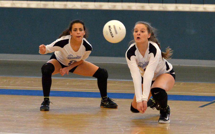 Brussels' Olivia Friedhoff digs deep to get a Sigonella serve as teammate Sophia Beckley watches. Sigonella beat Brussels 25-17, 21-25, 25-17, 25-22 to take the Division III title at the DODEA-Europe volleyball finals in Kaiserslautern, Germany, Saturday, Nov.4, 2017. 
                