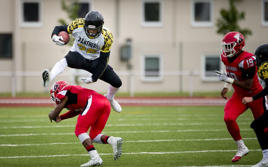 Stuttgart's Gabe Simpson jumps over Kaiserslautern's Ashton Moses in Kaiserslautern, Germany, on Saturday, Sept. 9, 2017. Stuttgart won the game 30-9.