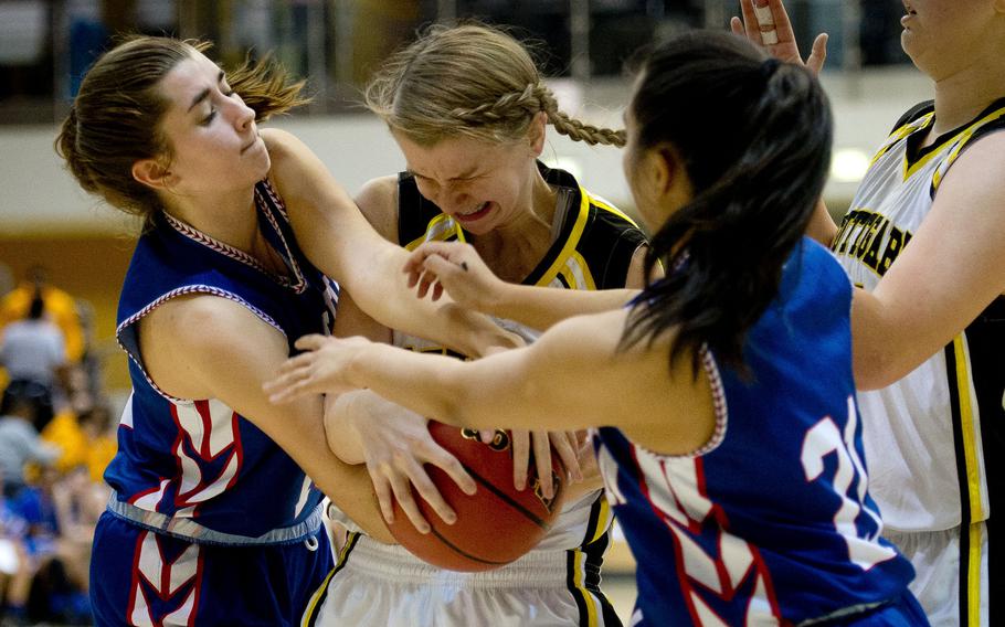 Stuttgart's Chyann Fox battles Ramstein's Kaitlyn Daniels, left, and Ashley Mateo for the ball during the DODEA-Europe Division I championship in Wiesbaden, Germany, on Saturday, Feb. 25, 2017.
                