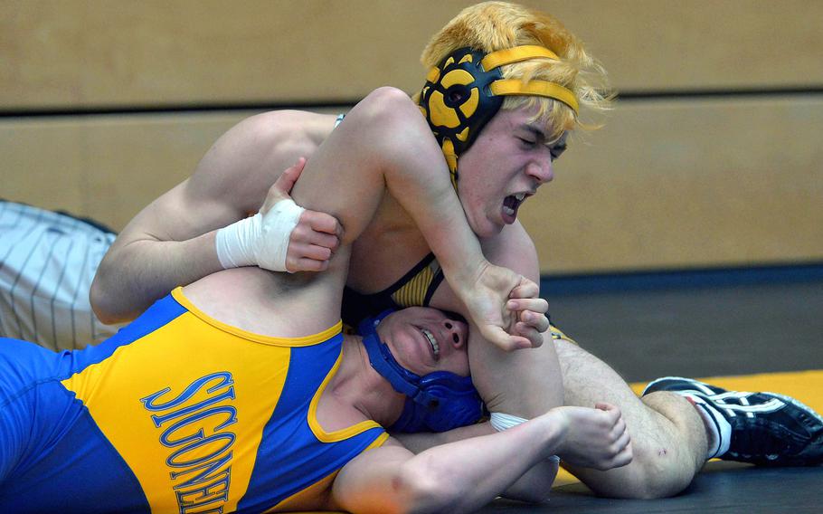 Sigonella's Cain Brehmer tries to get out of the grip of Stuttgart's Maximillian Tortorelli in a 145-pound, second-round match at the DODEA-Europe wrestling championships in Wiesbaden, Germany, Friday, Feb. 17, 2017.Tortorelli went on to win.
                