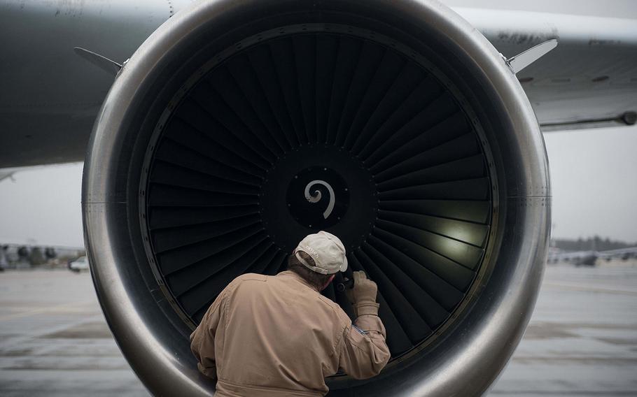 Brian Elit inspects NASA's DC-8 Airborne Science Laboratory during pre-flight checks at Ramstein Air Base, Germany, on Wednesday, Jan. 24, 2018.