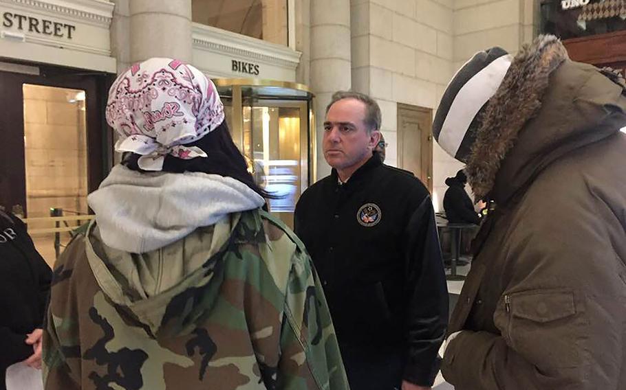 Department of Veterans Affairs Secretary David Shulkin, right, talks to Chasu Ardell Koker, left, a veteran recently evicted from her home. Volunteers secured housing for Koker on Wednesday, Jan. 25, 2018, through Chesapeake Health Educational Program, Inc., a nonprofit that offers a transitional housing program for veterans.