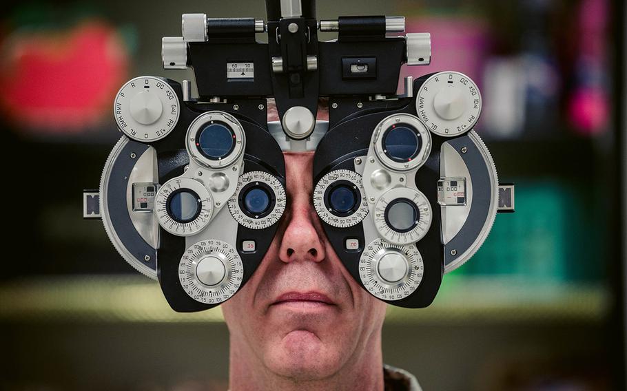 Air Force Lt. Col. David Miller, an optometrist assigned to the 442nd Medical Squadron assists in setting up a phoropter which will be used to give eye exams on Aug. 1, 2017.