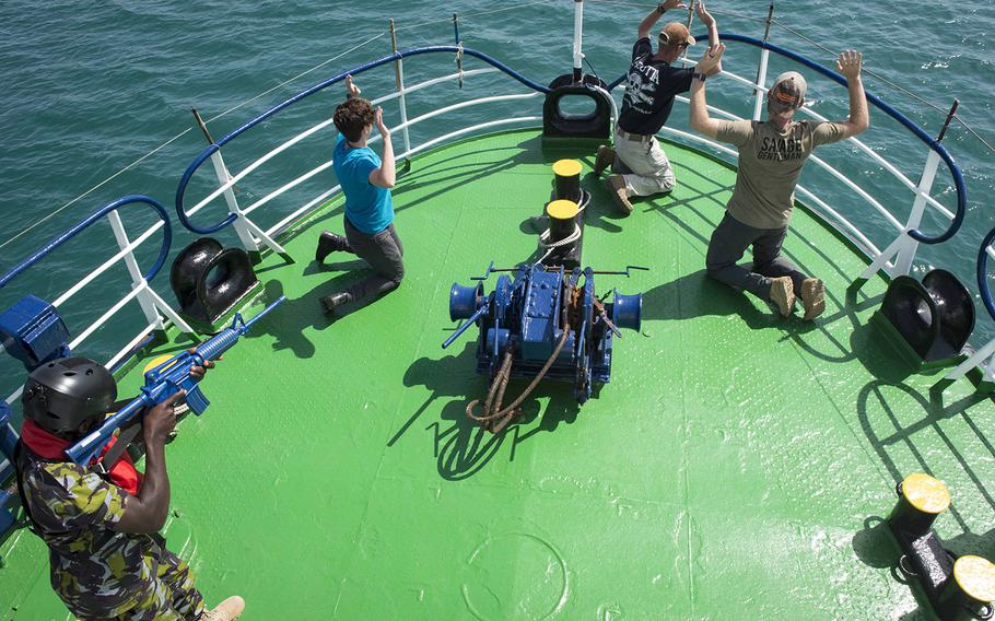 A member of the Kenyan navy takes part in a simulated raid aboard a ship near Djibouti on Tuesday, Feb. 6, 2018, for Cutlass Express. The exercise is designed to improve maritime policing and cooperation between U.S., East African and western Indian Ocean nations.