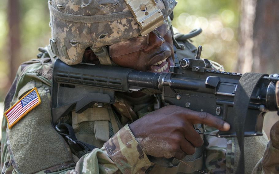 In a November, 2016 file photo, Pvt. Rolando Swaby, an Army Reserve Soldier in basic combat training with Company A, 1st Battalion, 61st Infantry Regiment at Fort Jackson, S.C., takes aim at his target at the hand grenade assault course.