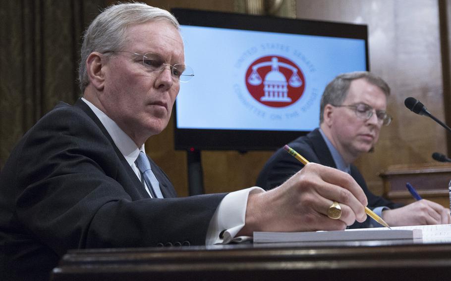 John H. Gibson II, left, the Defense Department's chief management officer, and David L. Norquist, the DOD comptroller and chief financial officer, take notes as Sen. Bernie Sanders, I-Vt., speaks during a Senate Budget Committee hearing on Capitol Hill, March 7, 2018.